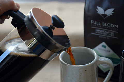 Pour fresh brewed French press coffee into a mug