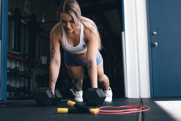athletic woman working out next to jump rope