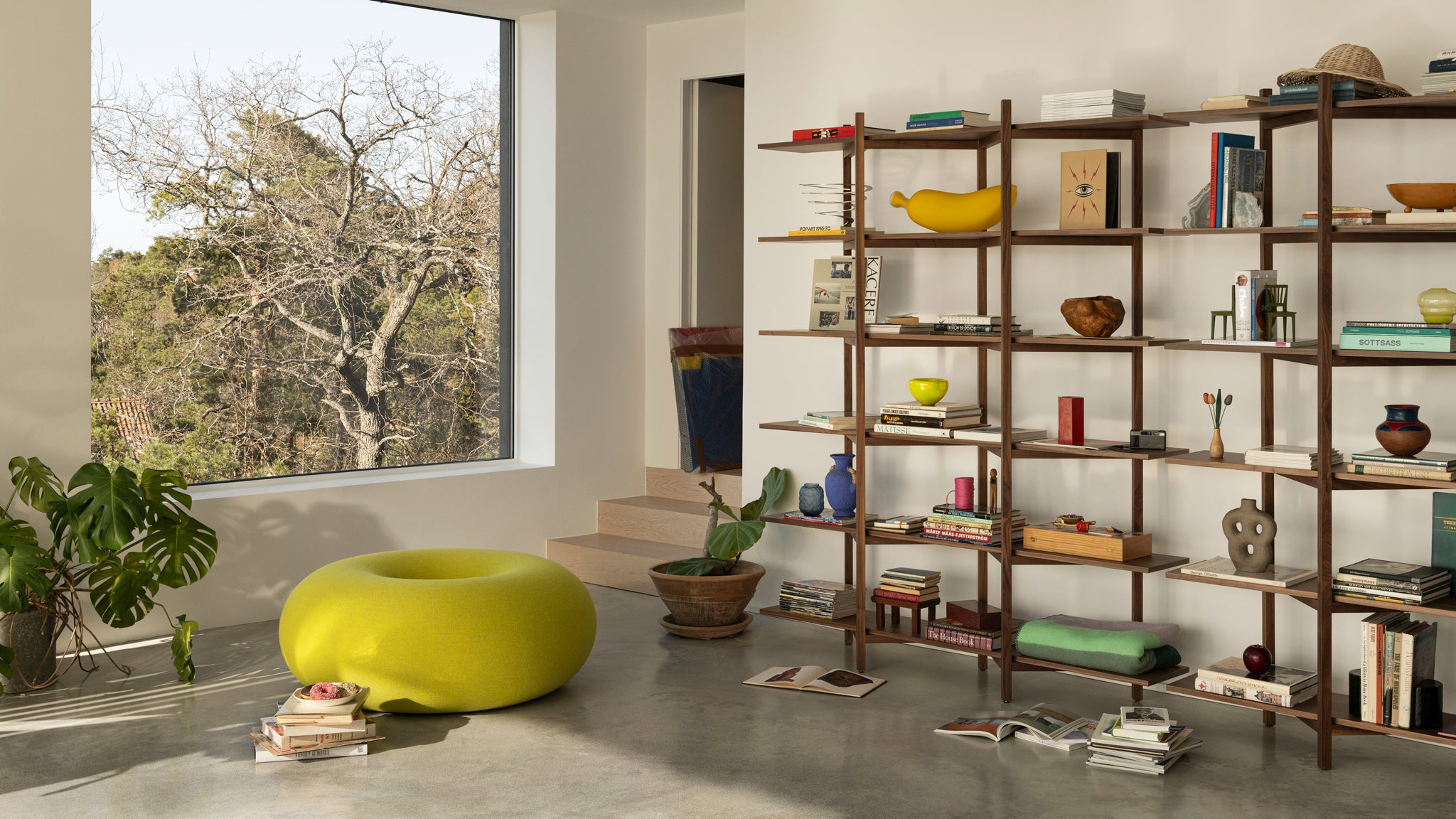 A lounge scene featuring Zig Zag High Shelf in Walnut and Boa Pouf in Sulfur Yellow.