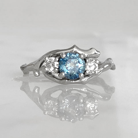 Platinum twig ring with Canadamark diamonds and montana sapphire