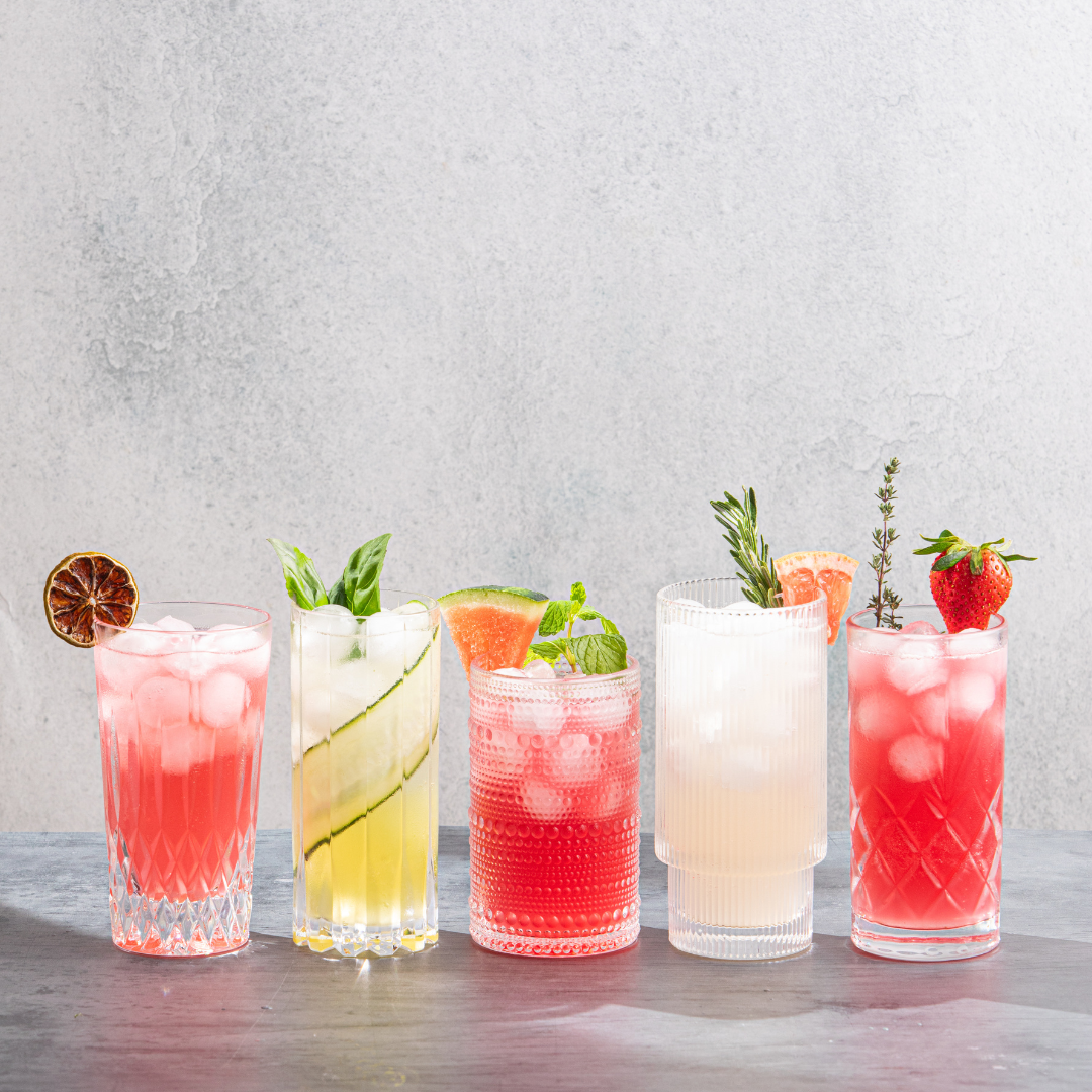 From right to left: Pink Rose Gin and Tonic, Cucumber Basil Gin and Tonic, Watermelon Mint Gin and Tonic, Grapefruit Rosemary Gin and Tonic, and Strawberry Thyme Gin and Tonic