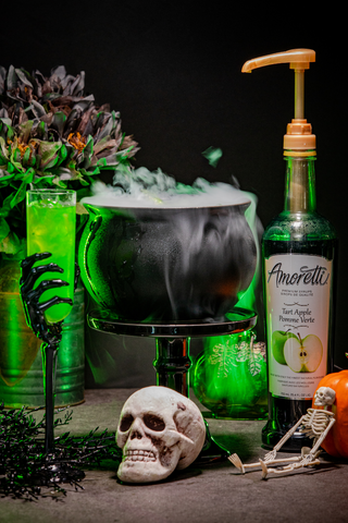 Spooky Witches Brew Cocktail Surrounded by Pumpkins and Skeletons