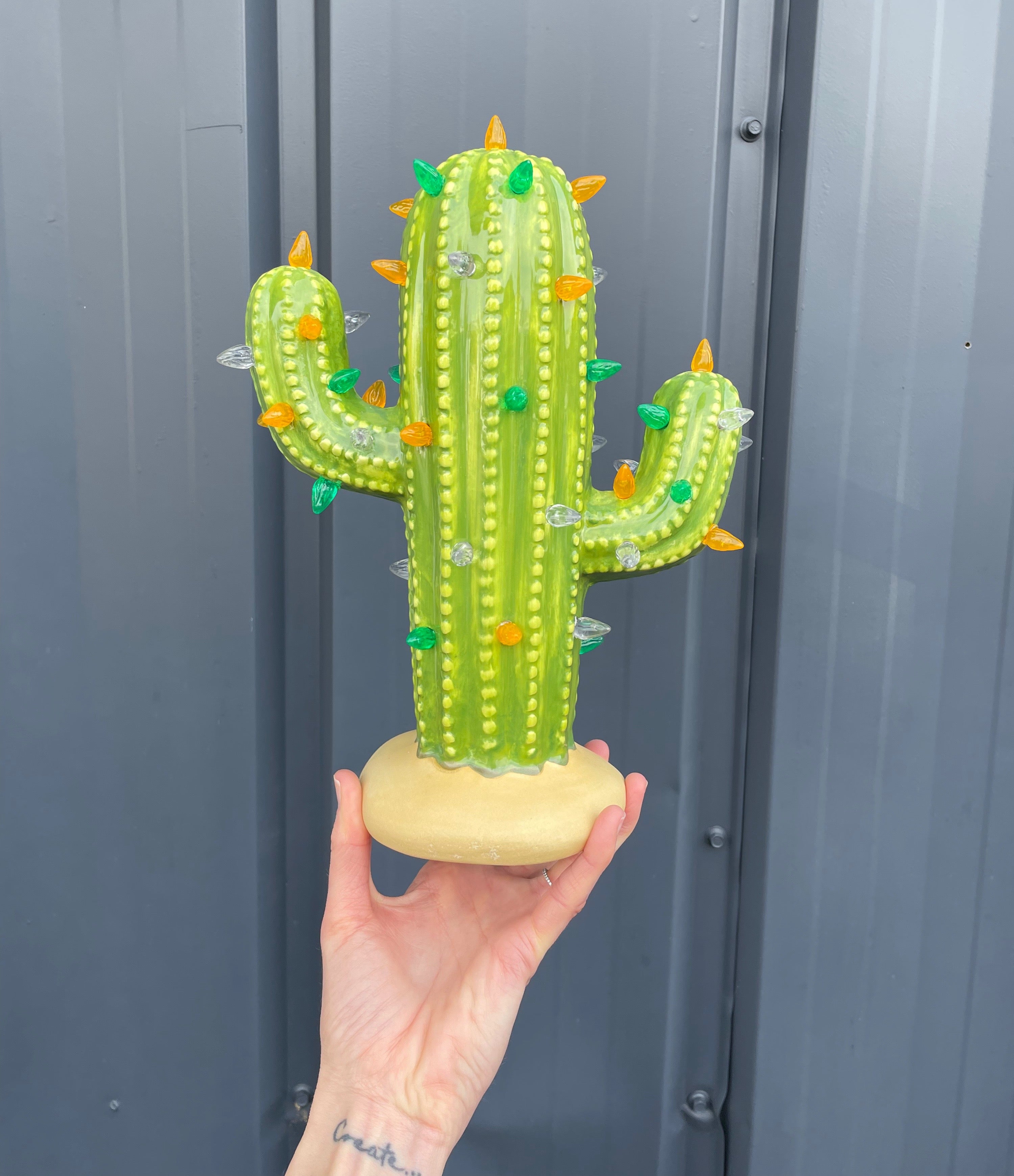 Holding St. Patrick's Day ceramic cactus by Brush Strokes Pottery