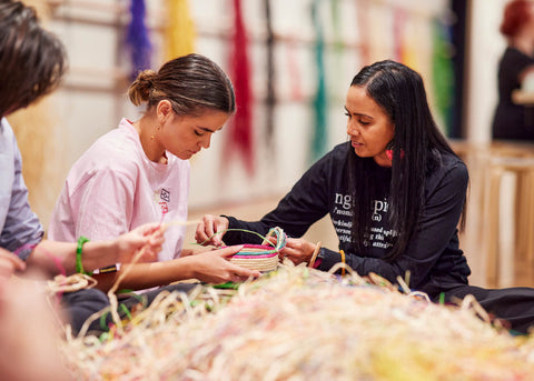 Tegan Murdock teaches a woman traditional aboriginal basket weaving for lunch lady magazine