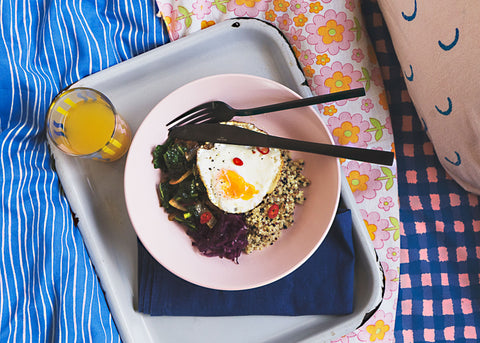 photo of eggs and green veg on a plate, on a tray in bed for lunch lady