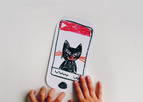 Photo of a homemade paper mobile phone with a cat picture on the screen