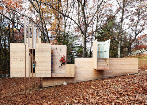 a photo of the five fields playground with a child rockclimbing on its wall