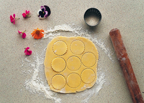 photo of biscuit dough on a table with a rolling pin for pressed flower biccies