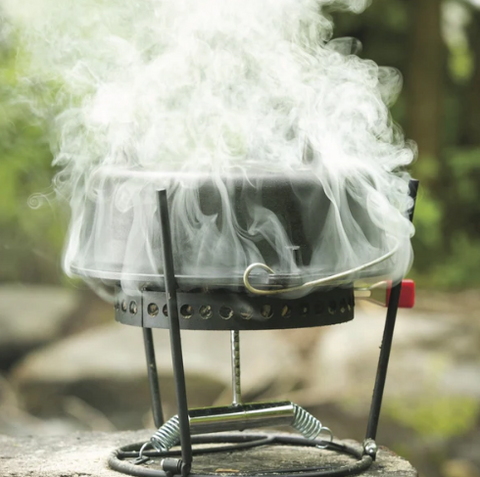 Dutch oven on a charcoal holder and serving stand.