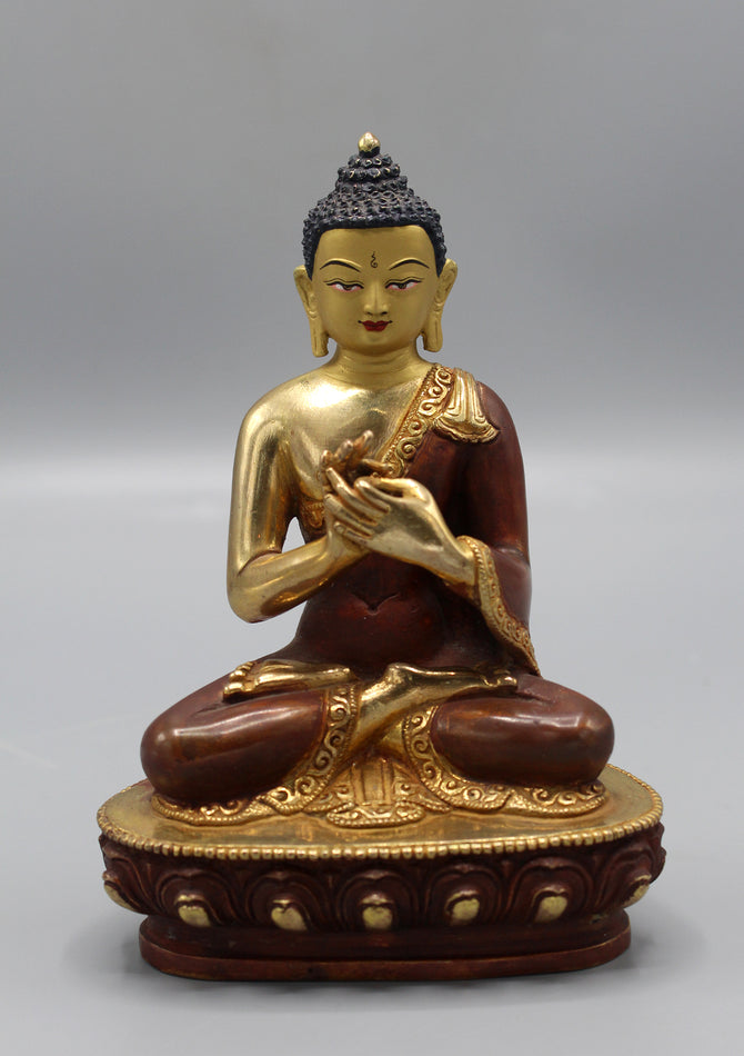 Meditating buddha statue in dharmachakra mudra known as teaching Buddha