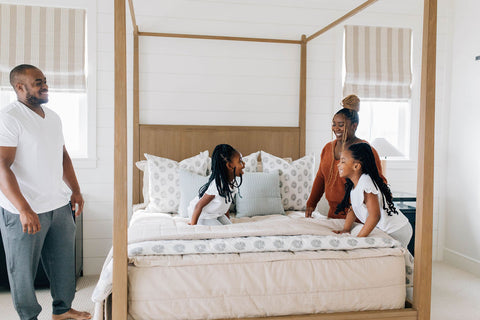 A family makes their bed with Beddy's zipper bedding.