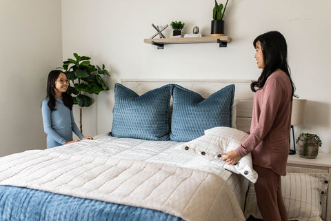 A woman and girl make their Beddy's zipper bed.