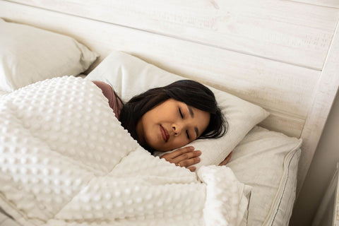 A woman is soundly sleeping in her Beddy's bedding.