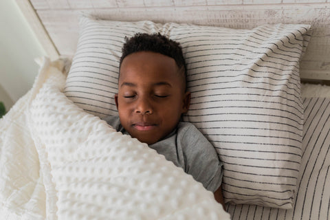 Young boy sleeping in his Beddy's zipper bedding.