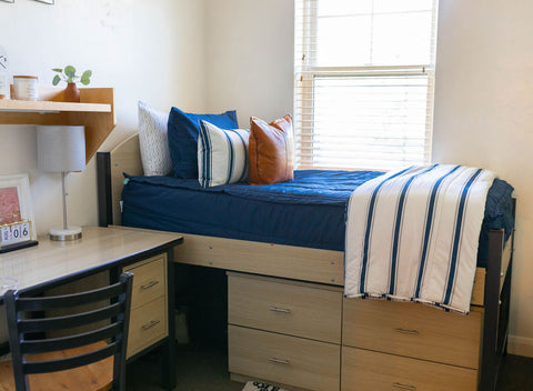 Zipper bedding enhances the functionality of a dorm room with a bed and desk.