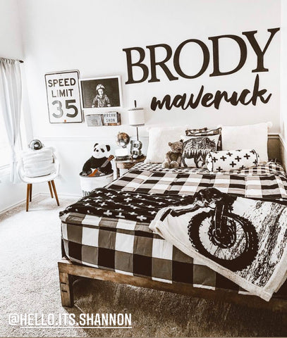 An image of a boys bedroom featuring Checked Out with the name Brody Maverick hanging on the wall above the bed,