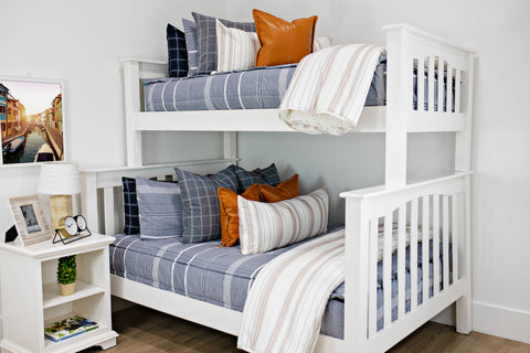 White bunk bed featuring blue zipper bedding.