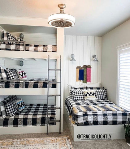An image of a bedroom featuring a triple bunk and a fourth bed to the right, all displaying our Checked Out Beddy's.