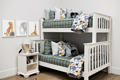 An image of a white bunk bed adorned with green bedding for children.