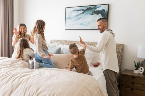 A family makes their bed with Beddy's zipper bedding.