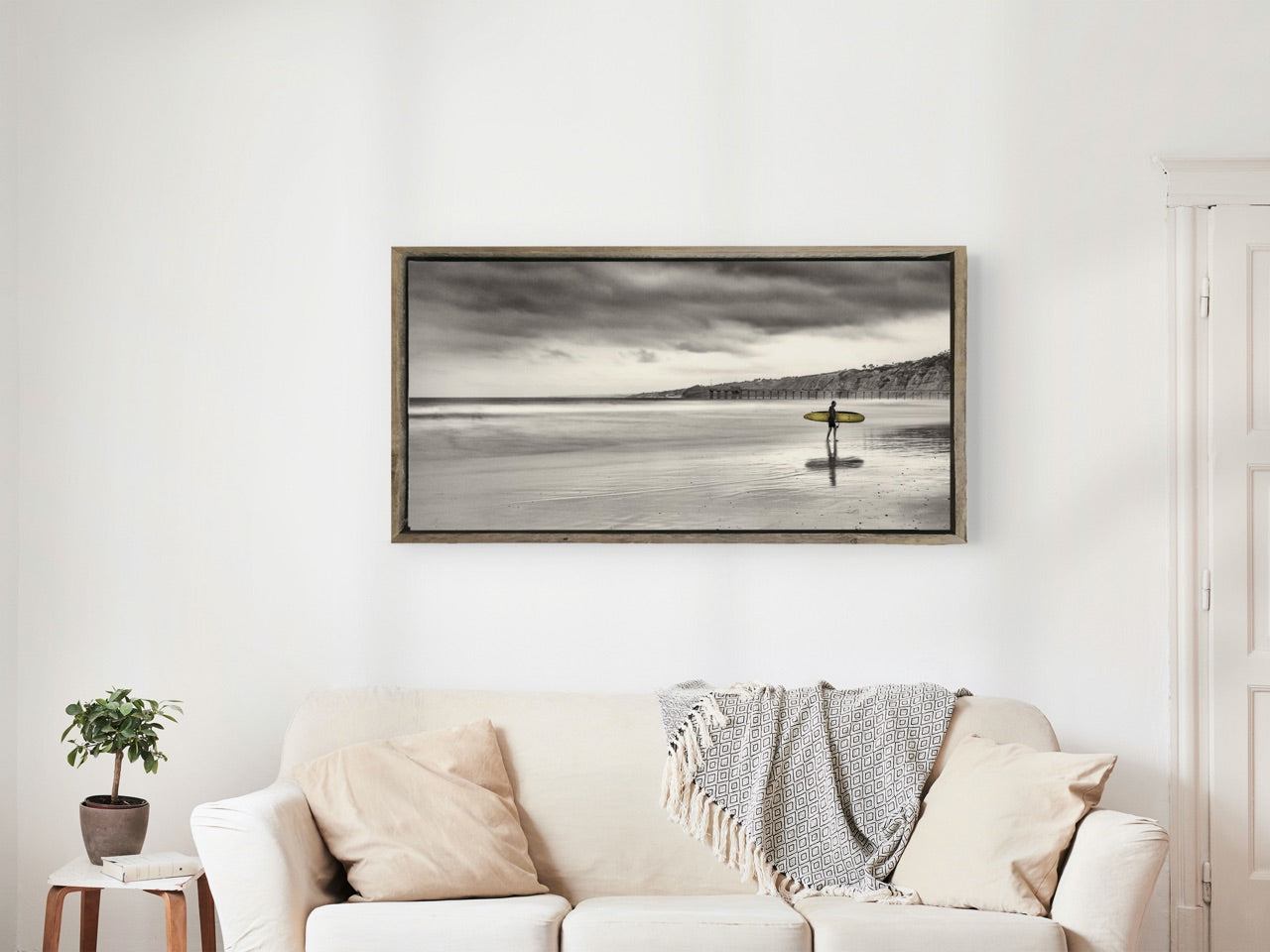 framed beach photography print over couch