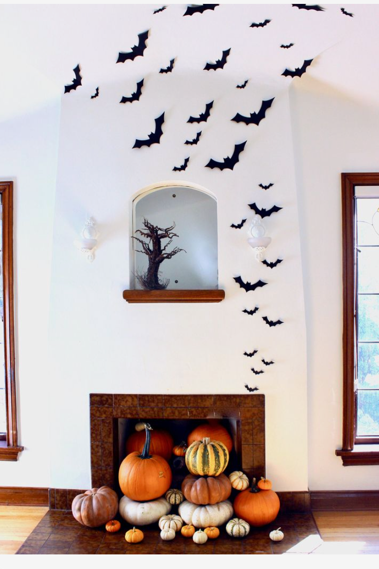 Halloween bats and pumpkins over fireplace