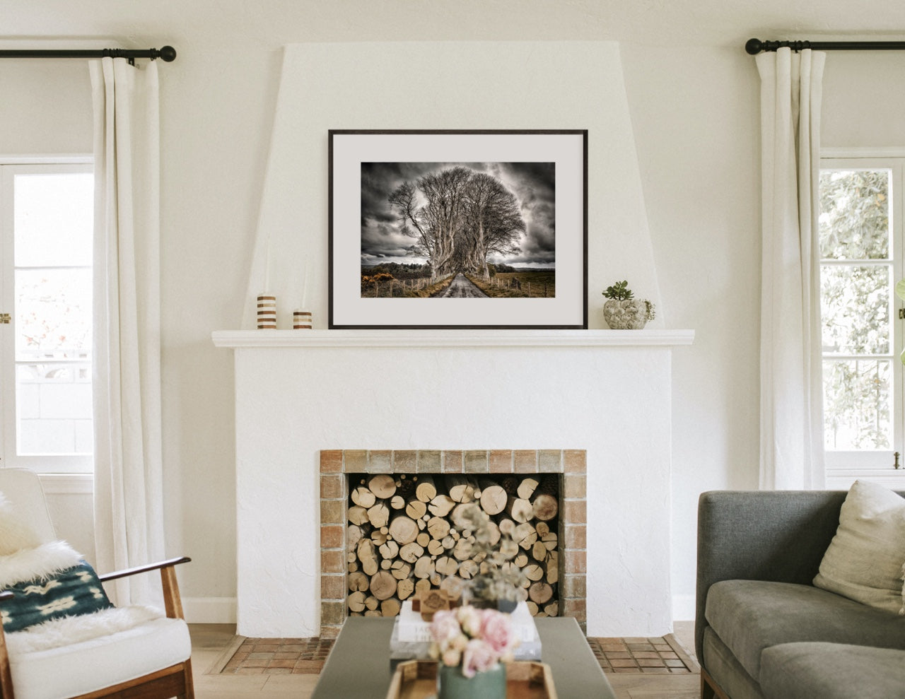Fireplace mantel with framed black and white tree art