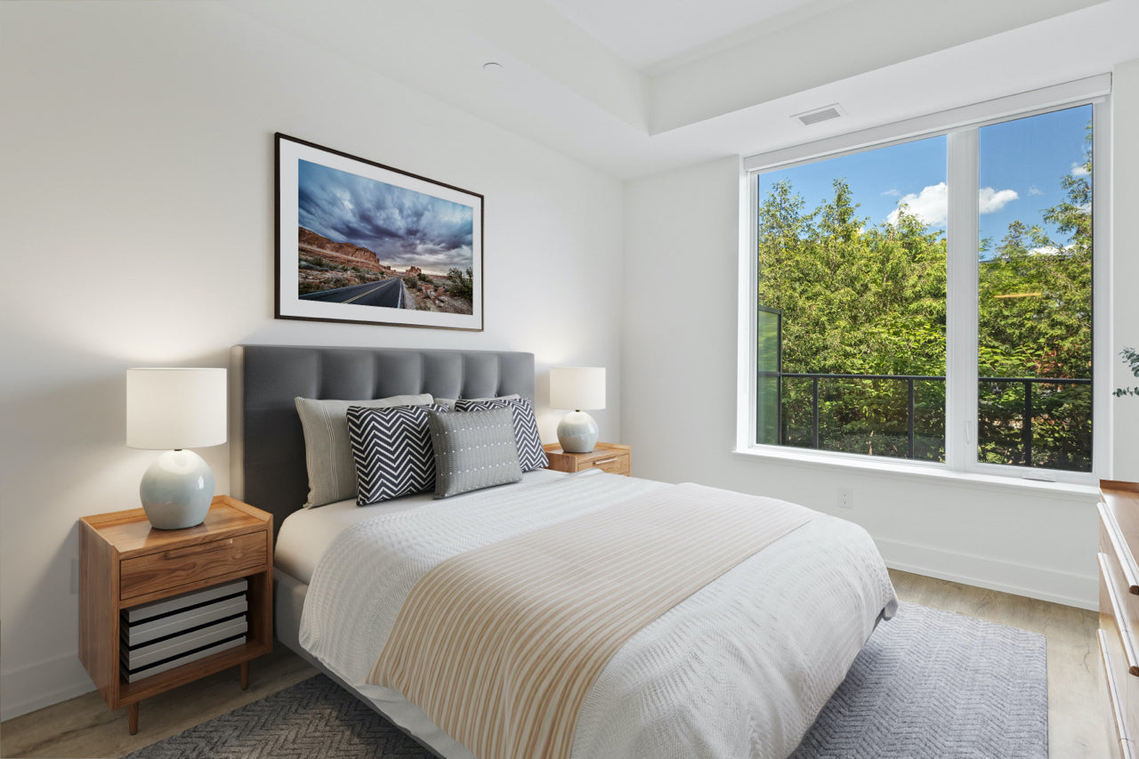 bedroom with large window and framed photograph