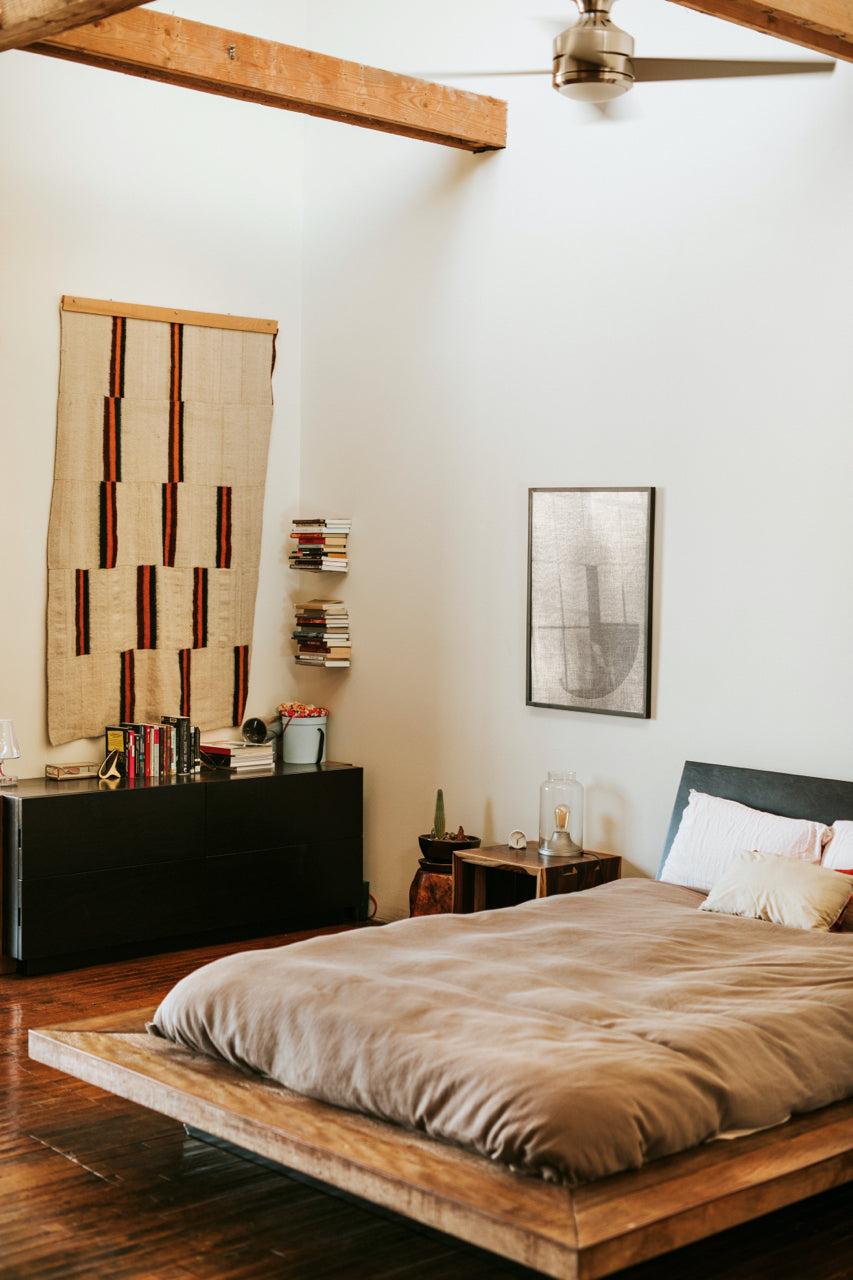 boho bedroom with woven wall decor