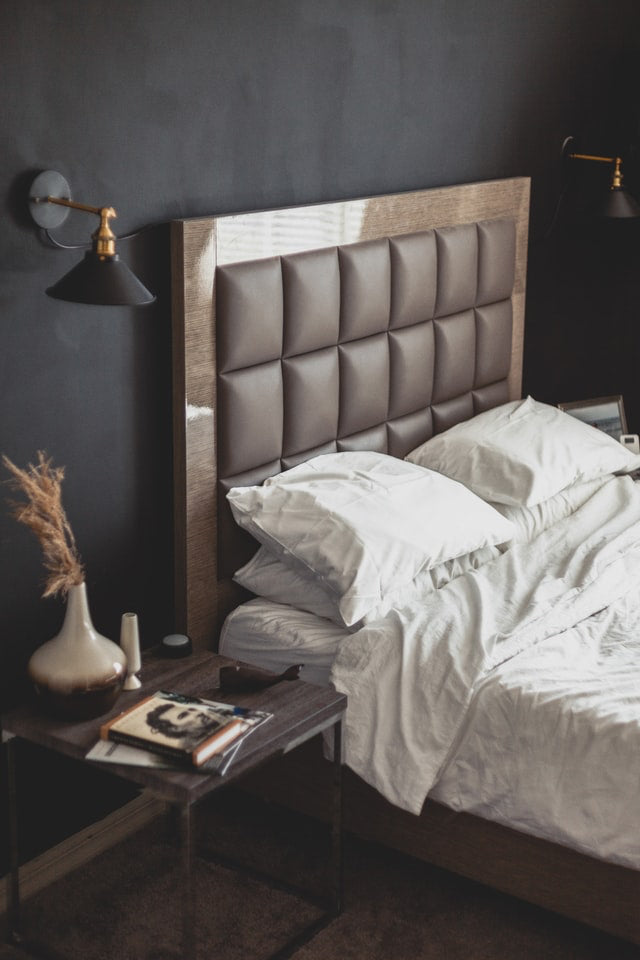 brown bed with black accent wall