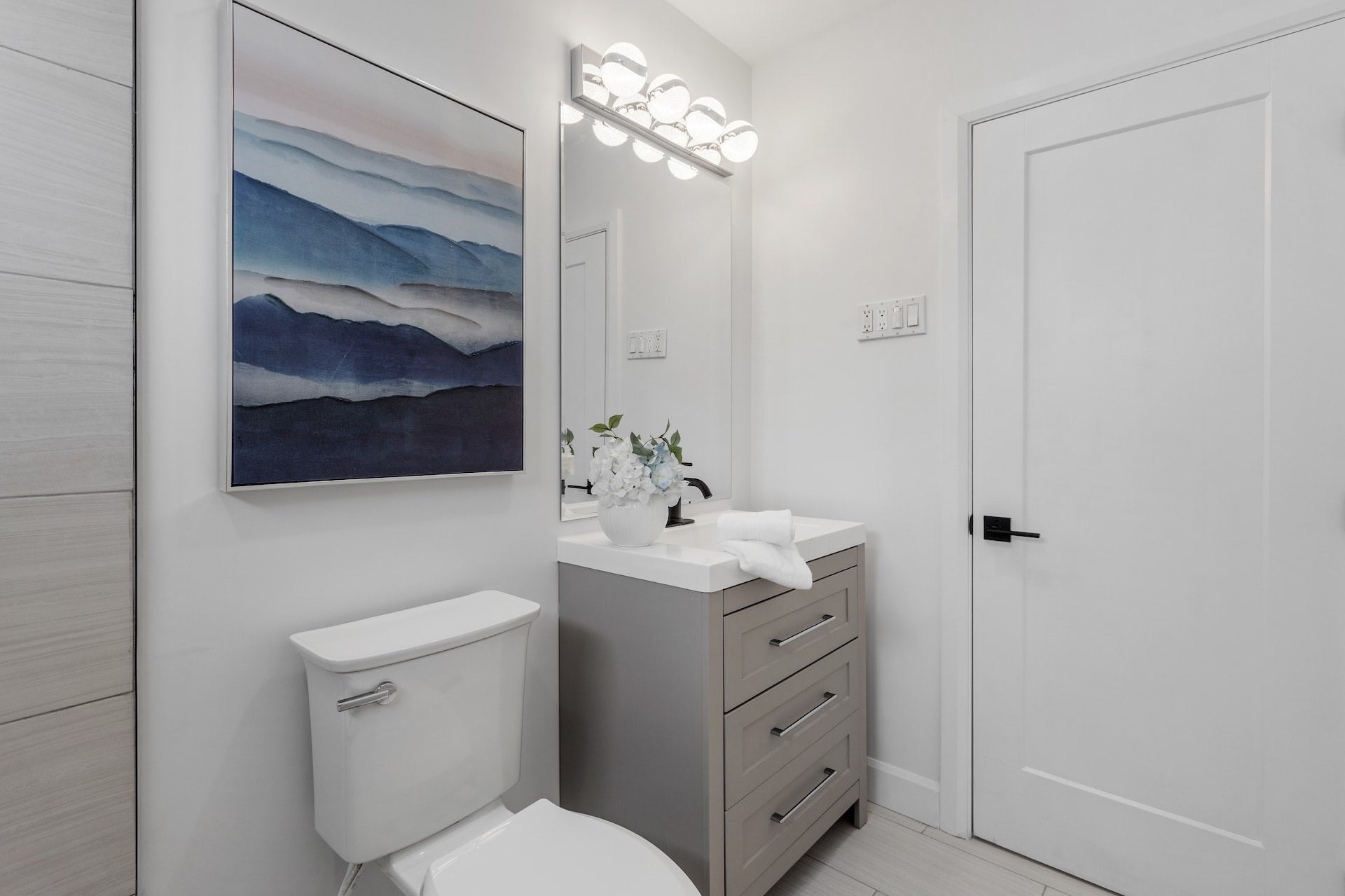 small bathroom with blue art