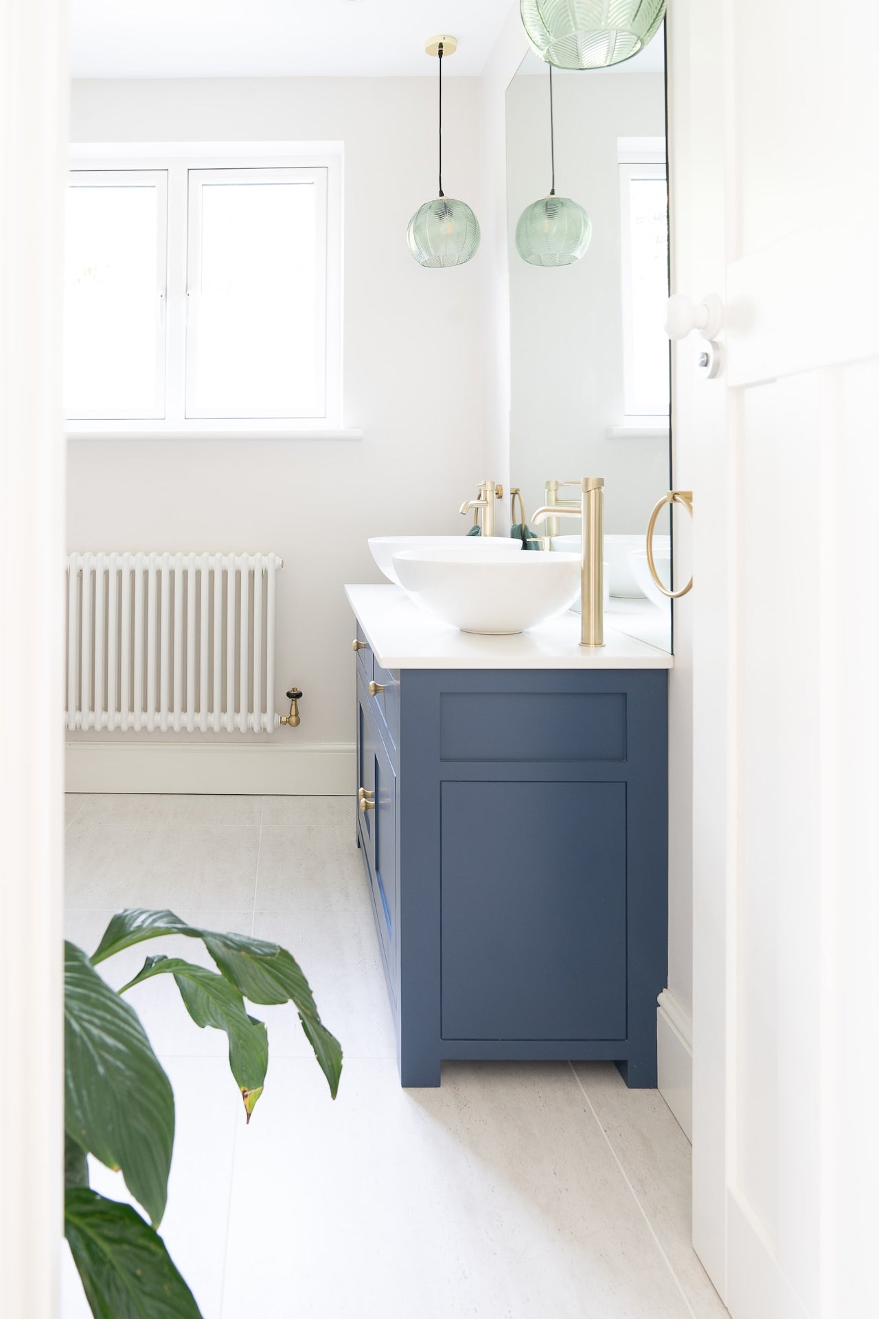 blue vanity in coastal white bathroom