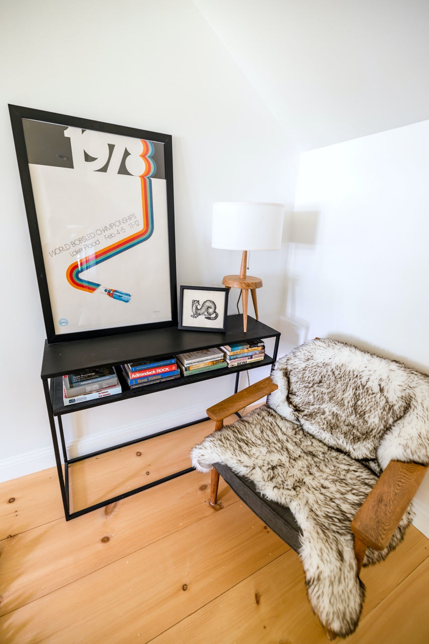 desk and chair with framed poster