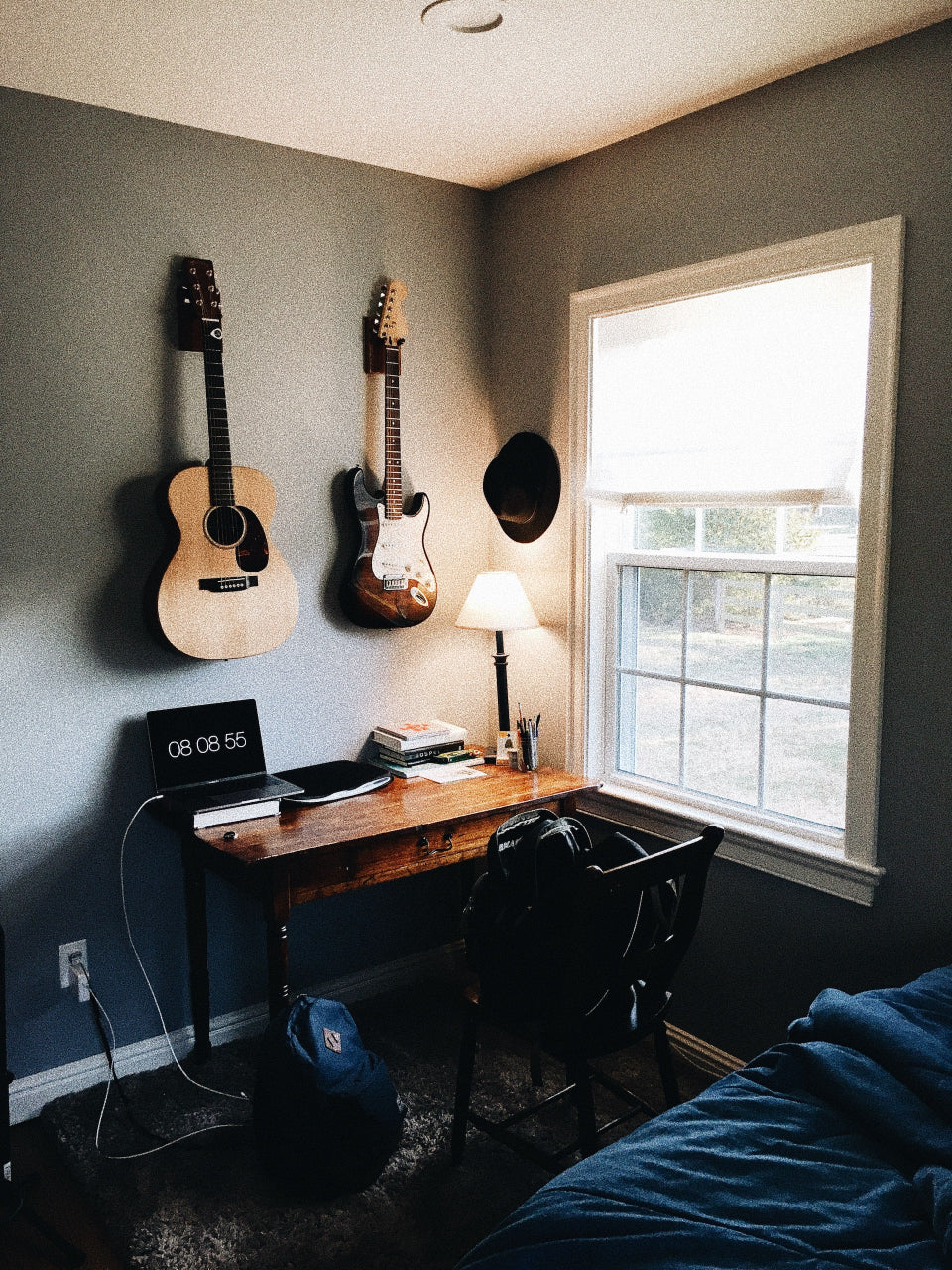 bedroom with guitars wall mounted