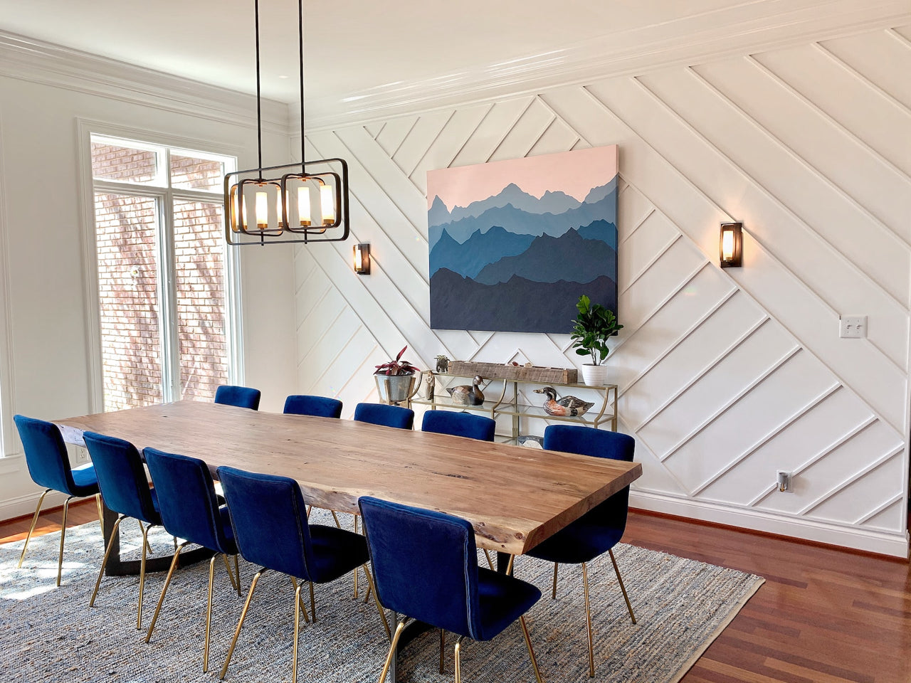 modern dining room with accent wall and blue chairs