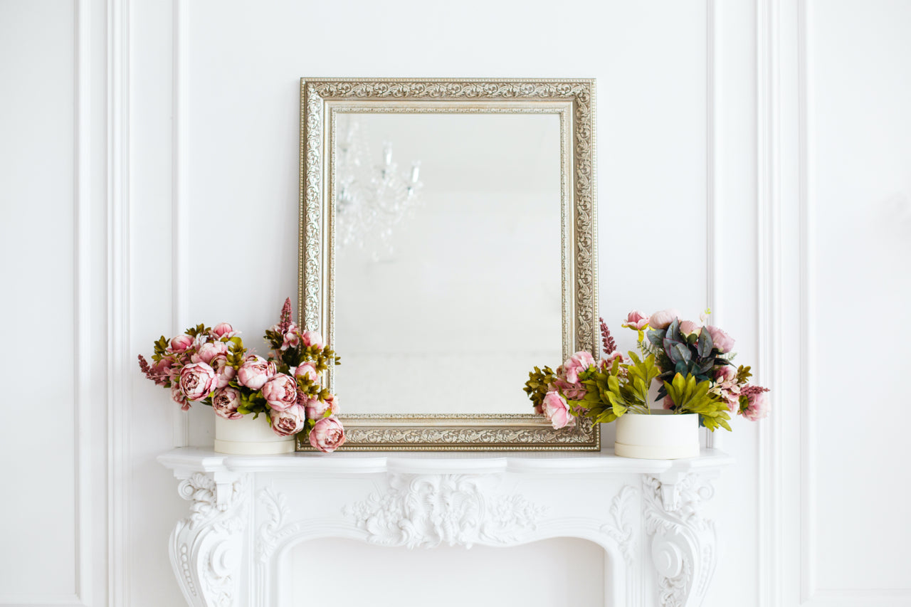 mirror and flowers on a mantle