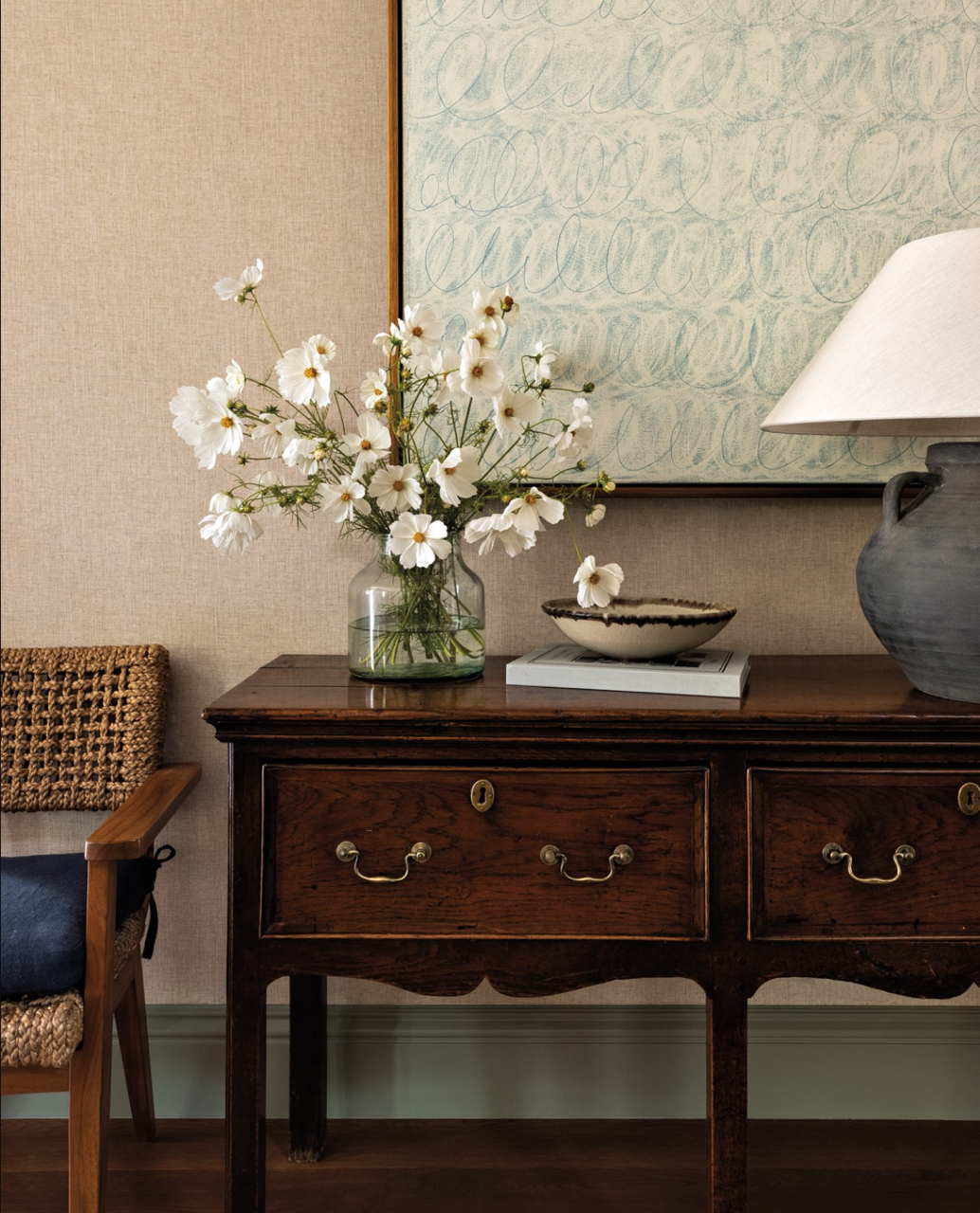 white flowers in vase in entryway