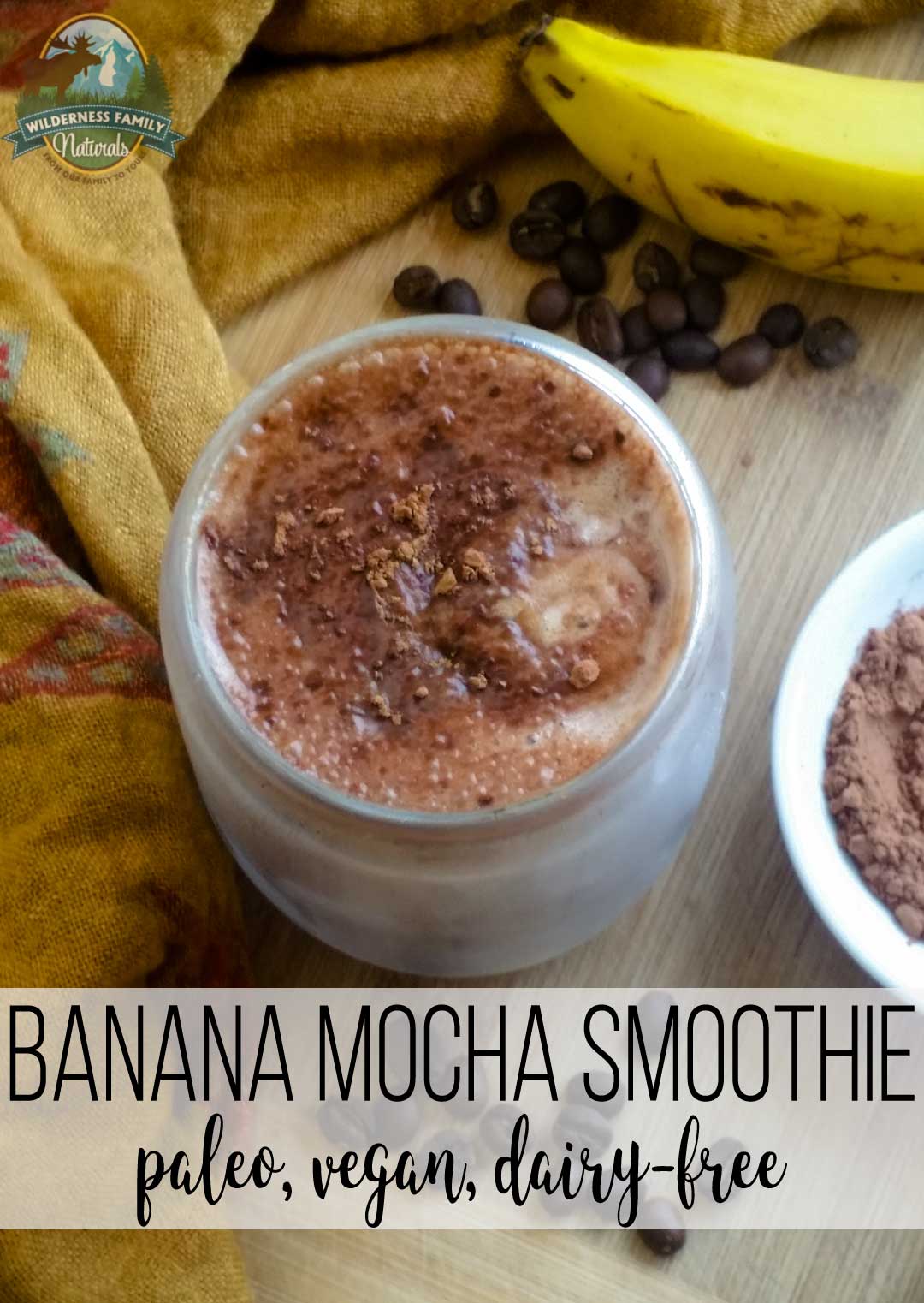 A mason jar filled with banana mocha smoothie with fresh bananas, raw cacao and coffee beans.