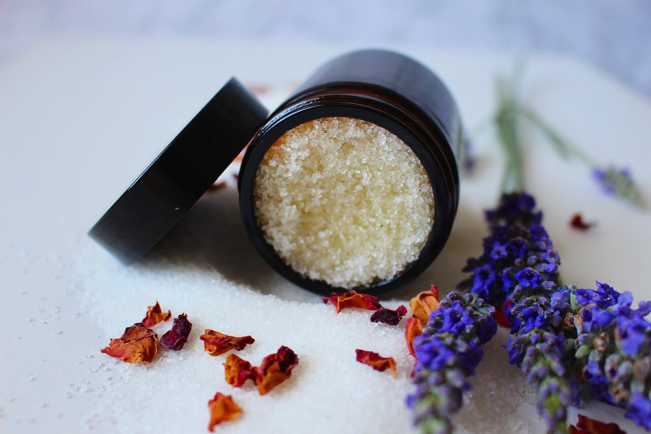 A tub of body scrub containing brown sugar