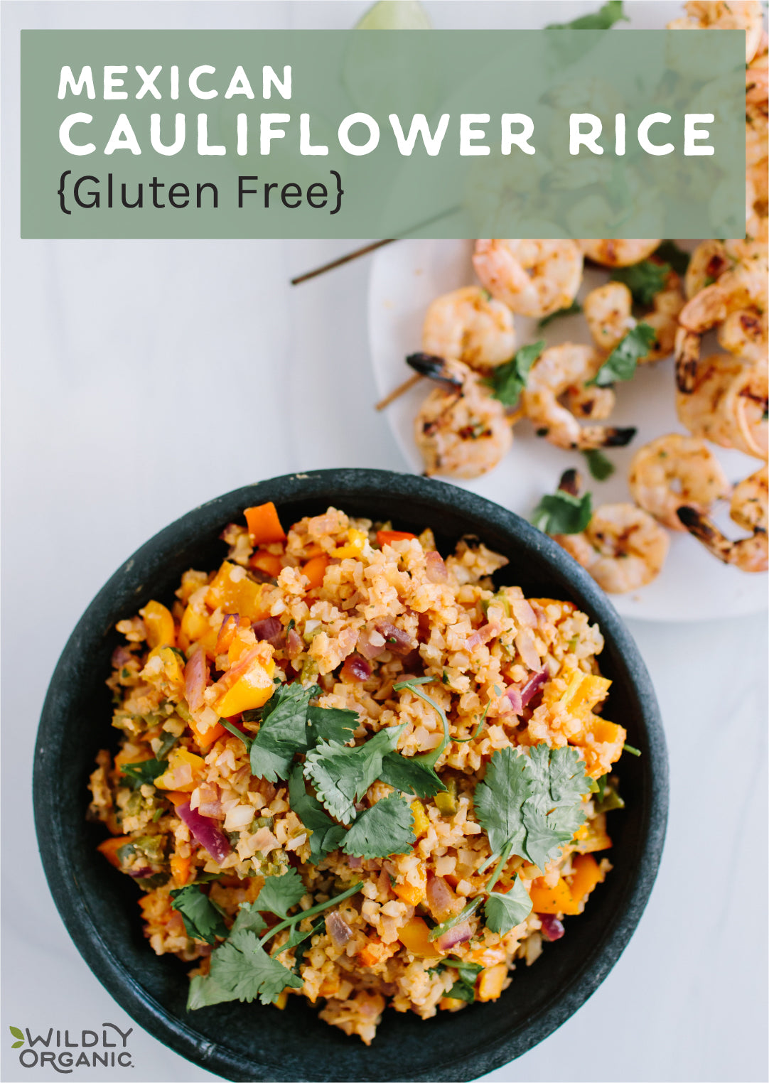 a bowl of Mexican cauliflower rice on a table with skewers of shrimp in the background