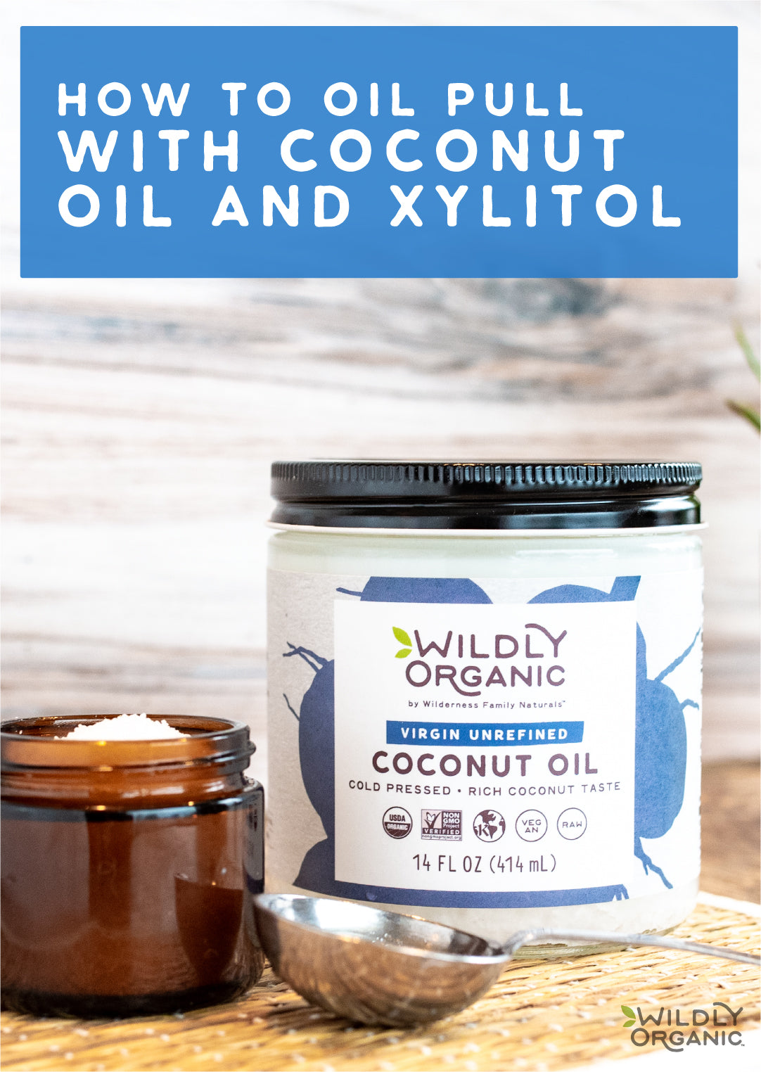 Jar of Wildly Organic Cold Pressed Coconut oil with metal scoop on wooden counter top