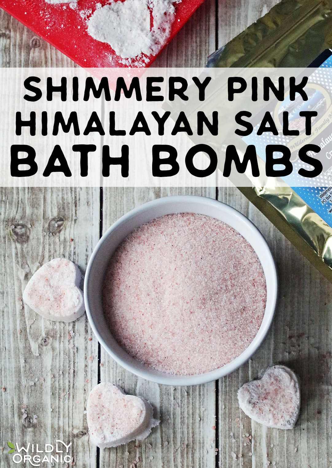 Photo of a bowl of salt with heart shaped bath bombs.