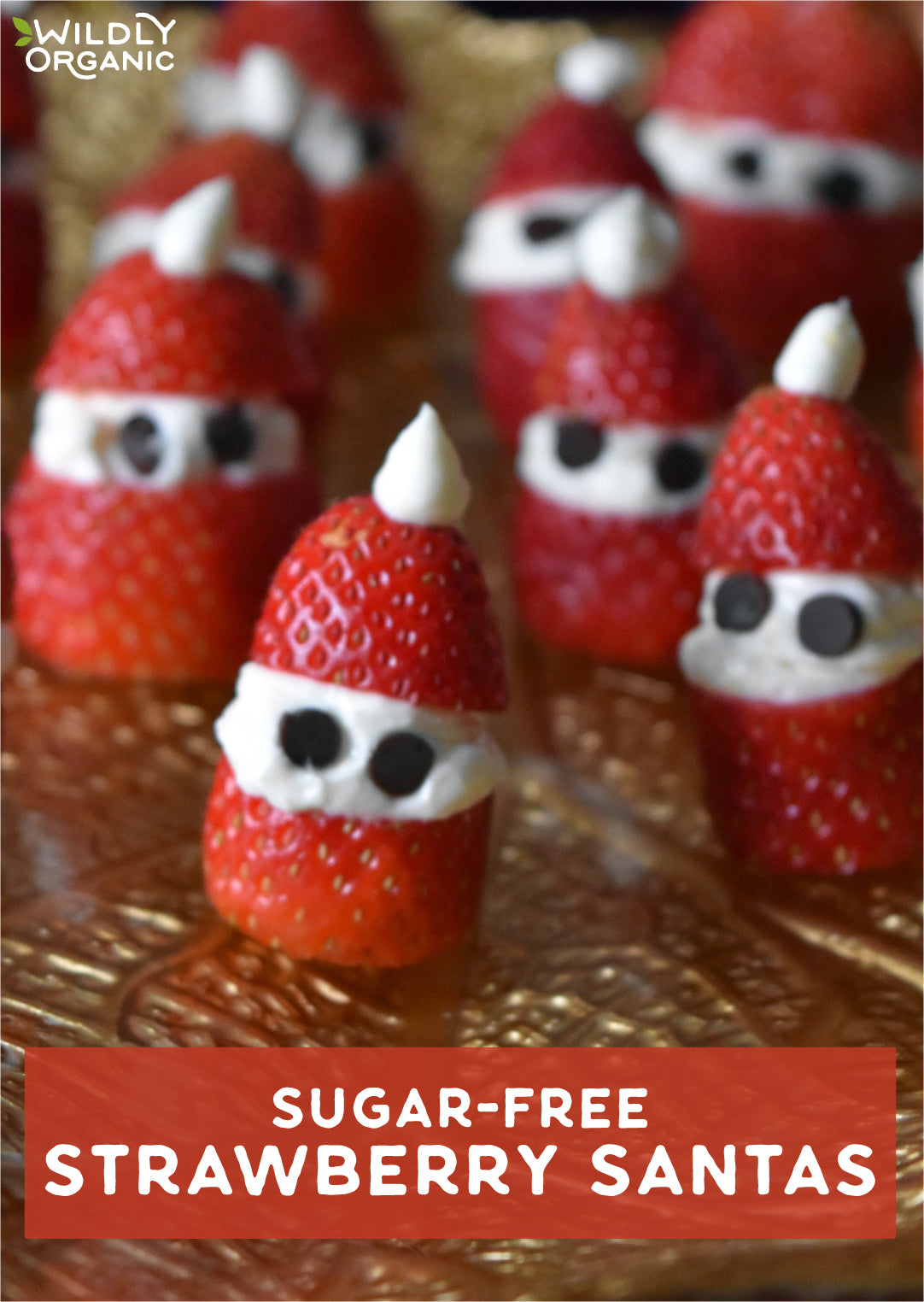 several strawberries with coconut cream filling in the shape of mini santa claus' on a tray for serving
