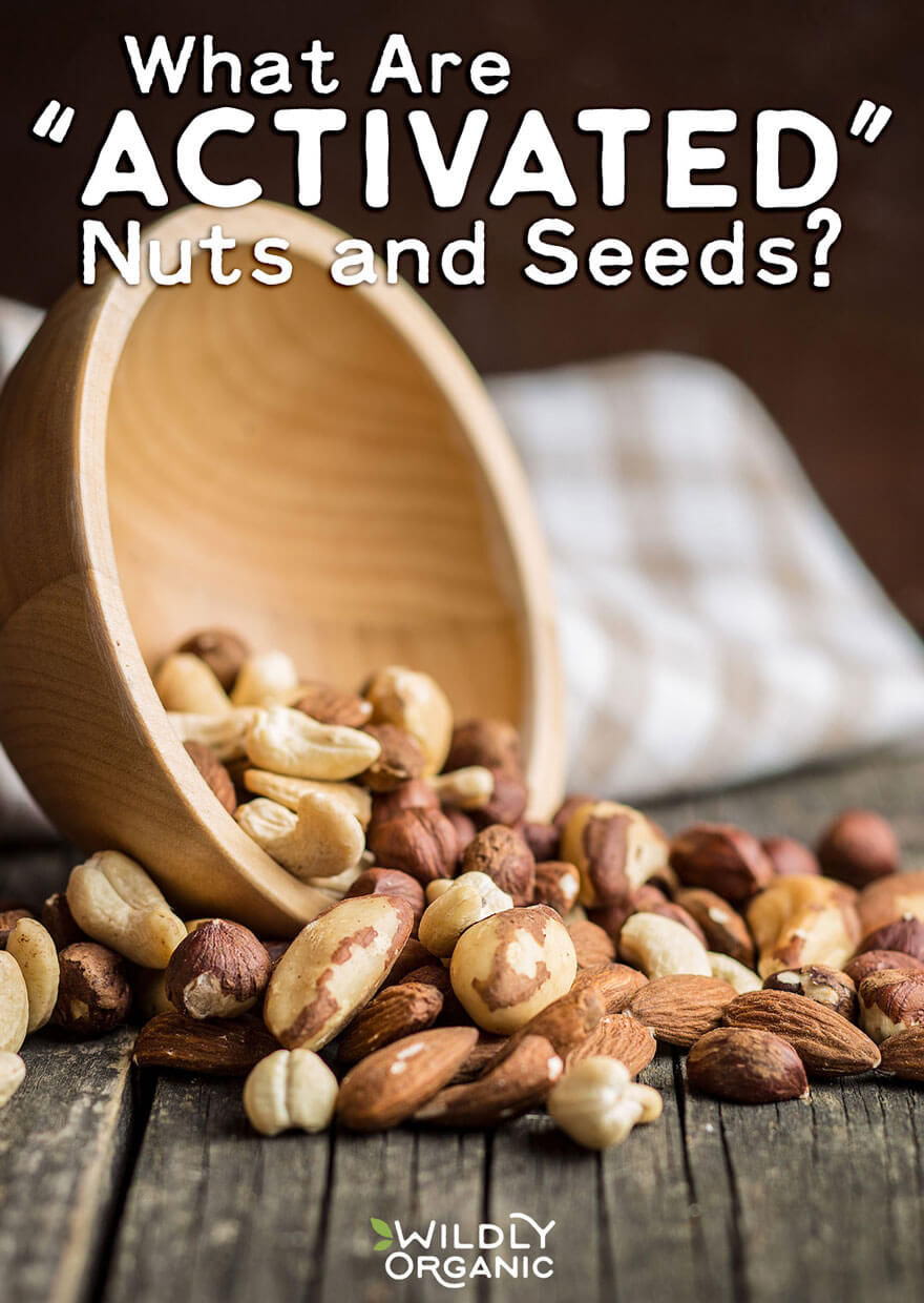 A side photo of bowl with cashews, hazelnuts, brazil nuts, and almonds on a distressed wood table and linen dish cloth.blog post image