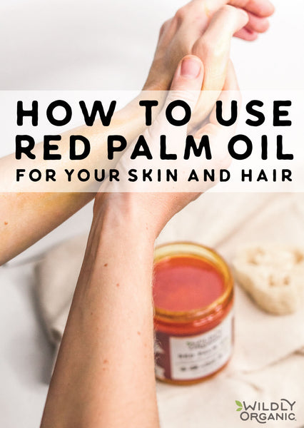 Hands applying red palm oil for its skin benefits