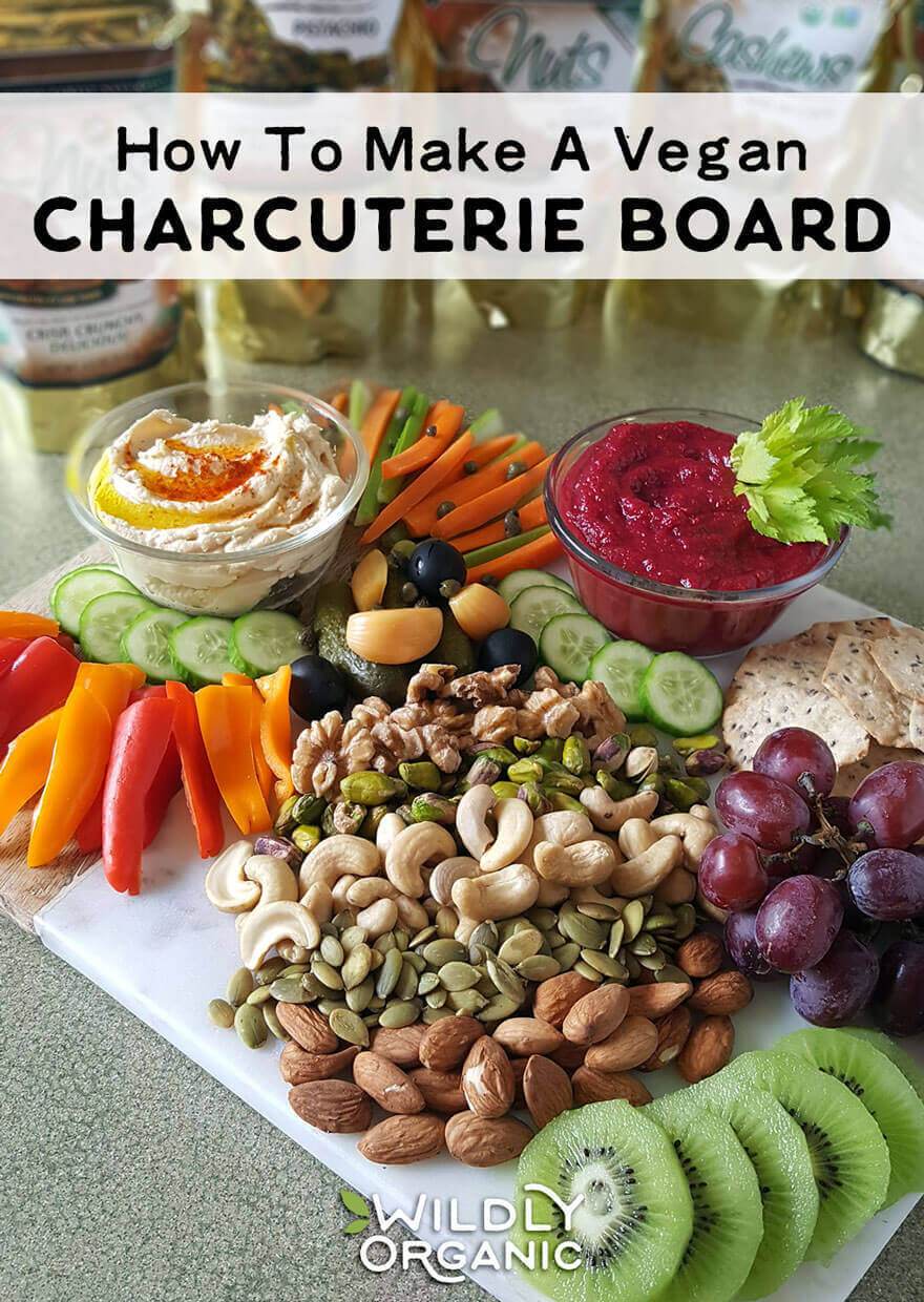 Photo of sliced veggies, nuts, dips, crackers, fruit, and more on a marble cutting board. | Charcuterie boards are fantastic for parties, movie night, and snacky weekend afternoons. They are also typically made with meats and cheeses. Why let the meat eaters have all the fun? I'll show you how to make a vegan charcuterie board that is beautiful, healthy, and will be sure to wow your family and friends!