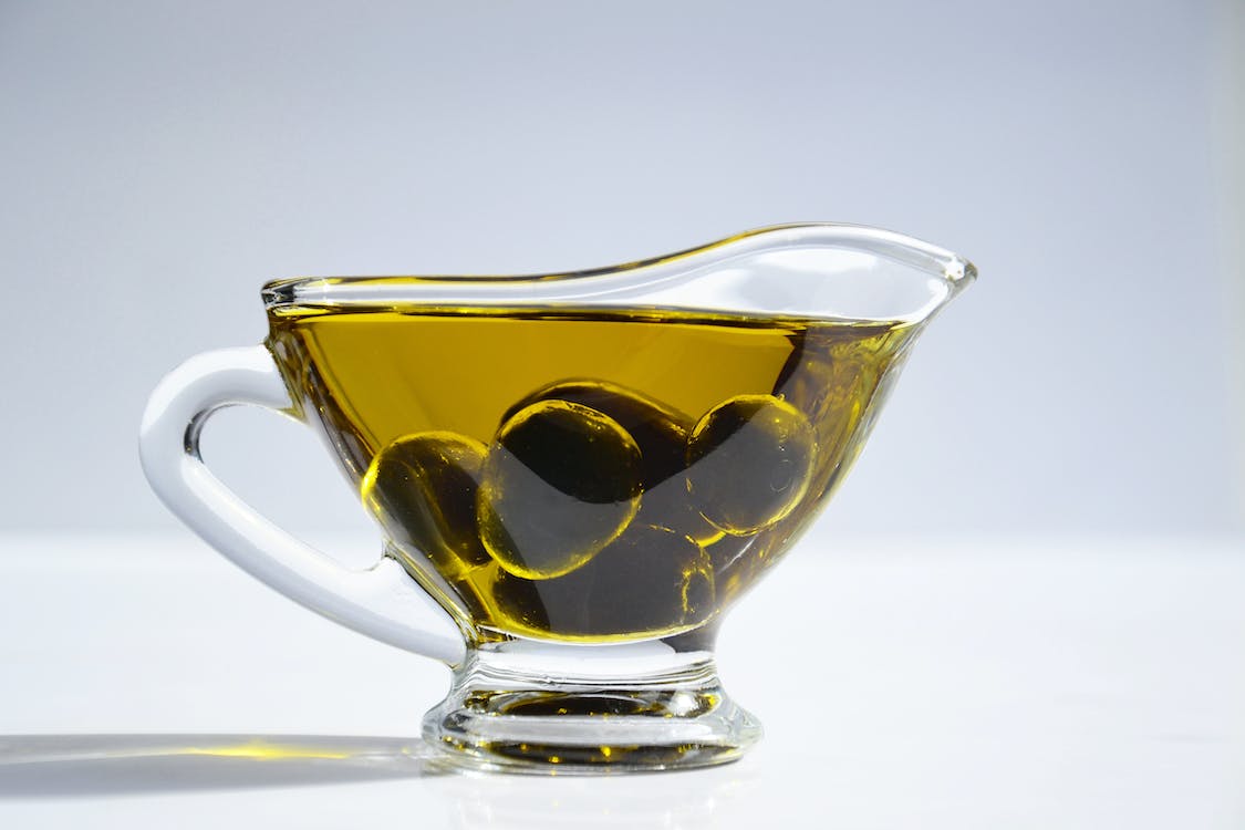 Olives and olive oil in a cup