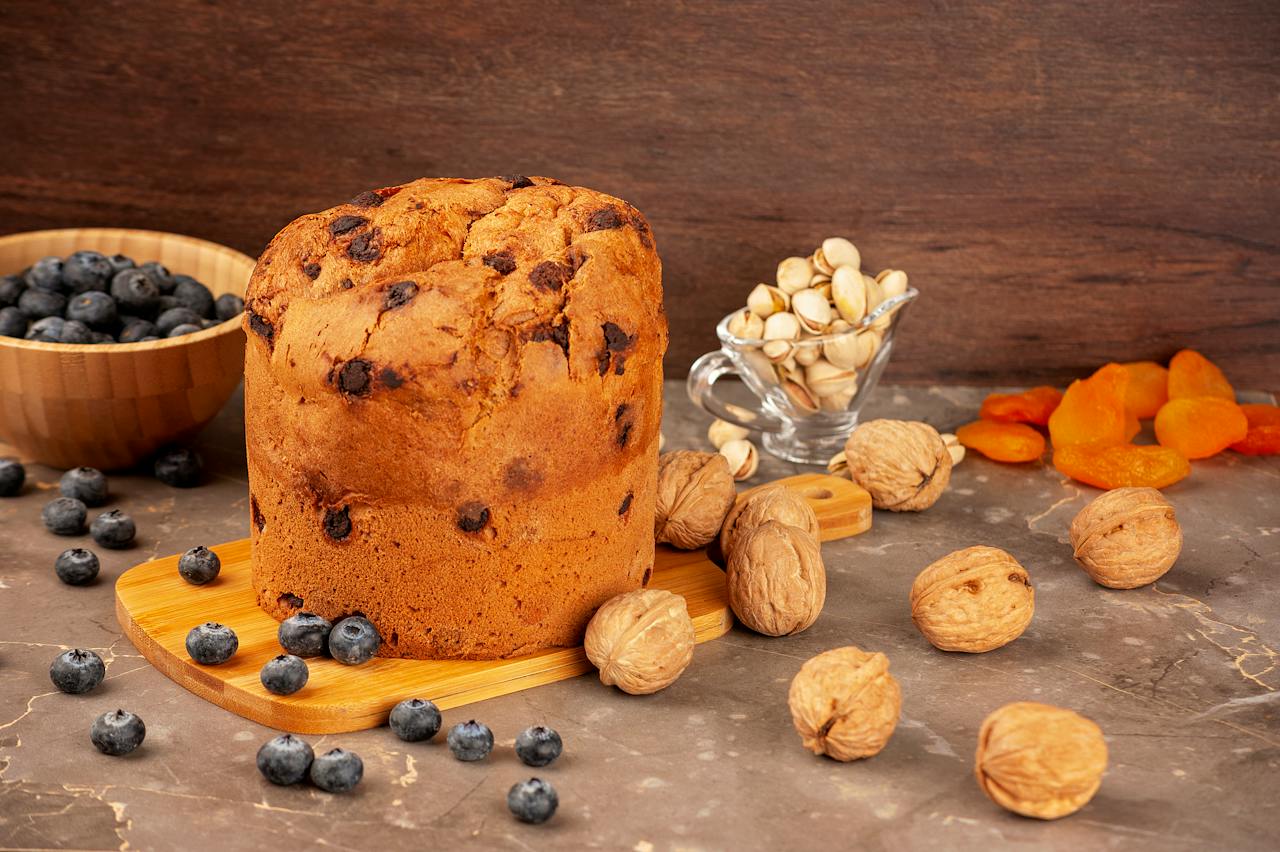 Walnuts and blueberries scattered around a cake