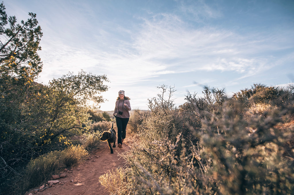 women out on a trail running with her dog wearing atlas pet company lifetime leash, lifetime collar & lifetime pouch