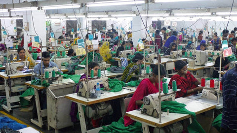 Factory workers in Bangladesh produce garments at very low prices.